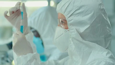 Lab Worker in Protective Coverall Suit and Mask Doing Research Stock Footage 171158030