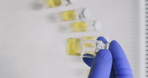 Lab worker in rubber gloves examines consistency of specimen Video stock 310314058