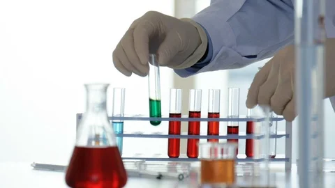 Lab worker sorts test tubes with chemicals Stock Footage 88380749