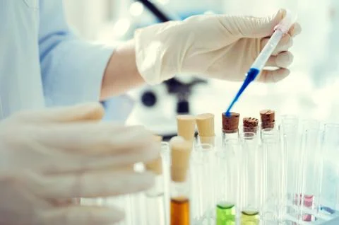 Lab worker using pipette while working with liquids Foto stock
