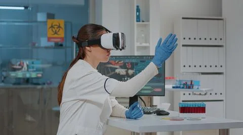 Lab worker using vr goggles with 3d projection in laboratory Stock Photos
