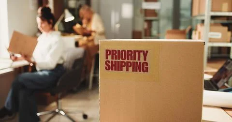Label, priority distribution and box in office for cargo with shipping for .. Stock Photos