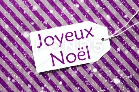 Label On Purple Paper, Snowflakes, Joyeux Noel Means Merry Christmas Stock Photos