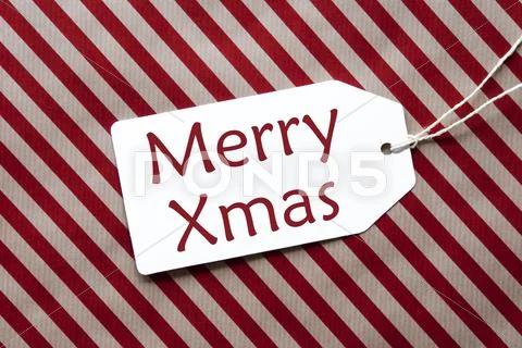 Label On Red Wrapping Paper, Text Merry Xmas Stock Photos
