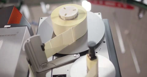 Label roll runs through an industrial printer, Food Factory 库存影片 340040272