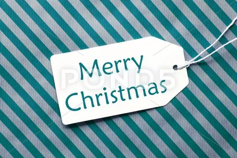 Label On Turquoise Wrapping Paper, Text Merry Christmas Stock Photos