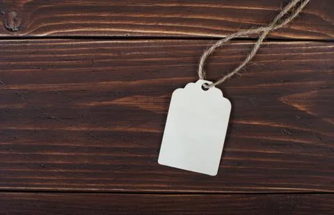 Label on a wooden beige background Stock Photos