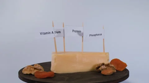 Labeled cheese with nuts and dried apricots Stock Footage 346472525
