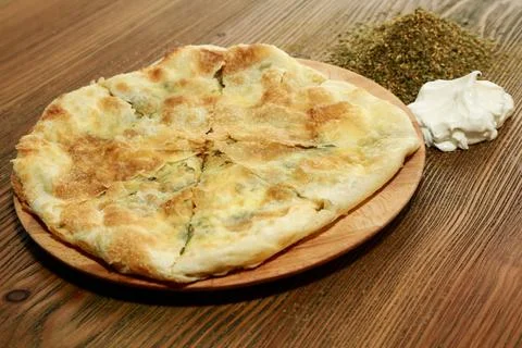Labneh and thyme pie served in wooden board isolated on table side view of .. Stock Photos