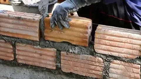 Labor build brick in construction site Stock Footage 98247911