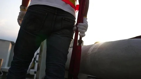 Labor man holding a pipe wrench with the warm light of the Sunset 库存影片 105913399