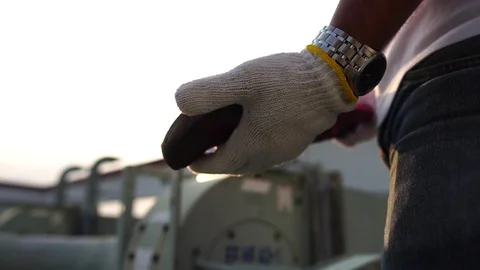 Labor man holding a pipe wrench with the warm light of the Sunset Stock-Footage 105913476
