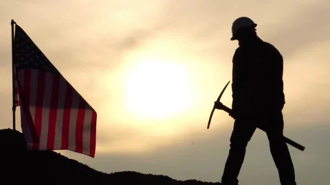 Labor man standing holding a pickaxe with the United States flag Stock Footage 106883721