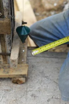 Labor man using a plumb bob for check . Stock Photos