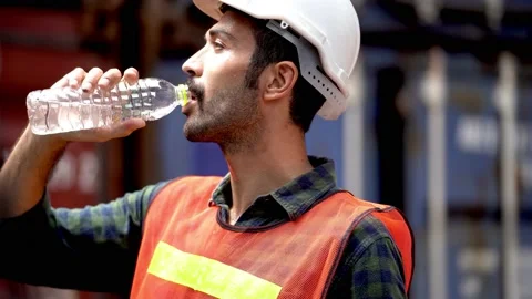 Labor man worker drinking water and relaxing after work. Stock Footage 138663734