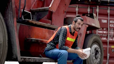 Labor man worker sitting relaxing after work at machine crane outdoor. Stock Footage 140238565
