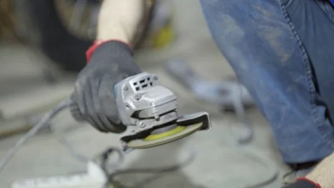 Labor worker sanding pieces of pipe with angle grinder machine Stock Footage 128919283