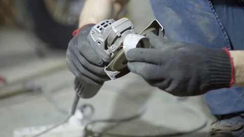 Labor worker sanding pieces of pipe with angle grinder machine Stock Footage 128919362