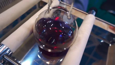 Laboratory appliance allows stir solution on a red flask Stock Footage 71653409