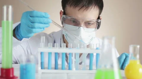 Laboratory Assistant Adds a Reactant Stock Footage 66257088