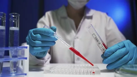 Laboratory assistant analyzing a blood sample Stock Footage 142252379