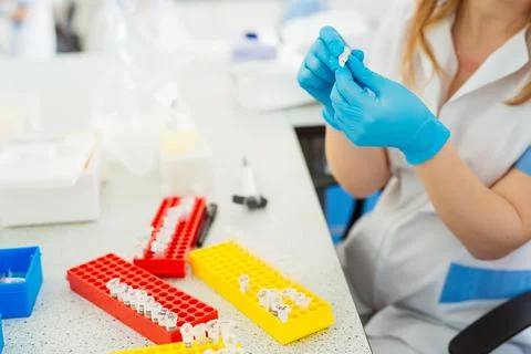 Laboratory assistant analyzing a blood sample. Medicine and science background Stock Photos