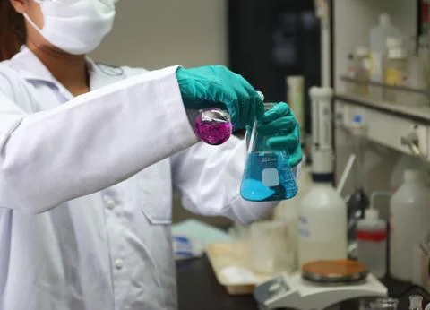Laboratory assistant analyzing a liquid Stock Photos