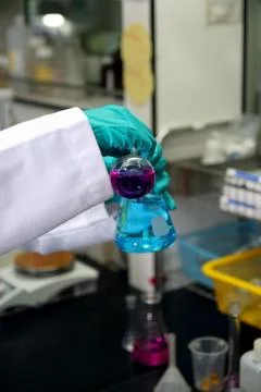 Laboratory assistant analyzing a liquid 스톡 사진