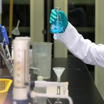 Laboratory assistant analyzing a liquid Stock Photos