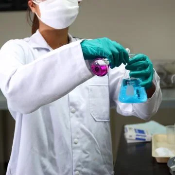 Laboratory assistant analyzing a liquid Stock Photos