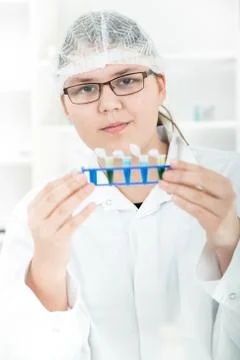 Laboratory assistant analyzing a liquid. Stock Photos