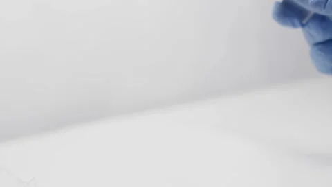 Laboratory assistant doing research of yellow antiviral substance in big syringe Stock Footage 86563187