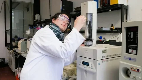 Laboratory assistant during her work at the Autosampler in the institute. Stock Footage 69315710