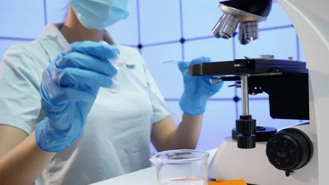 Laboratory assistant examines a drop of water Stock Footage 249660811