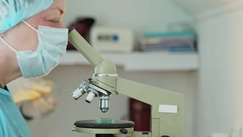 The laboratory assistant examines samples under a microscope. Research medicine. Stock Footage 172143870