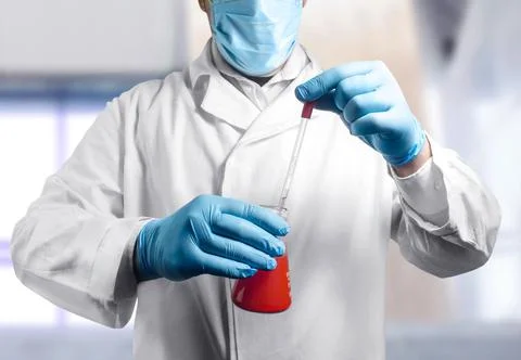Laboratory assistant with flask. Stock Photos