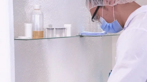 Laboratory assistant man examines materials Stock Footage 117407370