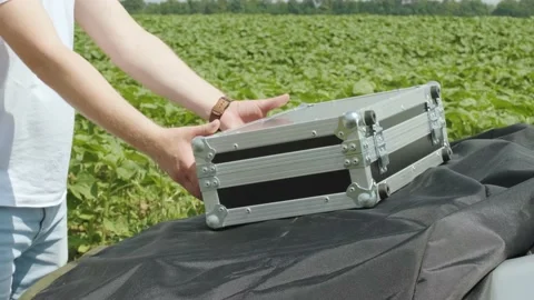 Laboratory assistant opens a case with laboratory equipment for plant analysis Stock Footage 134286448