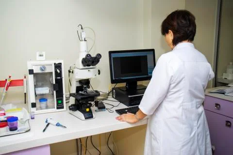 Laboratory assistant performs a blood test in a modern laboratory on the anal Stock Photos