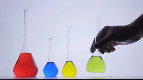 Laboratory assistant put colorful flasks bulbs on table. Researching coronavirus Stock Footage 128438814