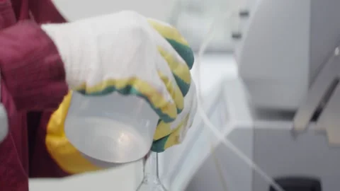 Laboratory assistant scientist pours the water into the flask Stock Footage 139492192