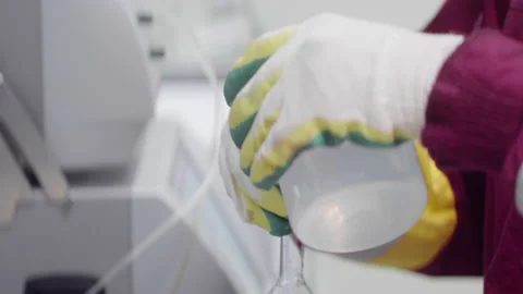 Laboratory assistant scientist pours the water into the flask Stock Footage 179523031