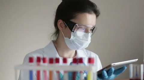 Laboratory Assistant with Test-tubes and Tablet Video stock 66256469