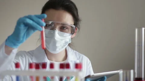 Laboratory Assistant with Test-tubes and Tablet Video stock 66256817