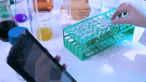 Laboratory Assistant Using Tablet to check Results Of Analysis Stock Footage 242412362