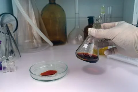 A laboratory assistant working with blood sample in laboratory. Stock Photos