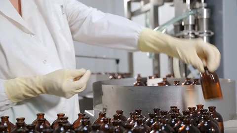 Laboratory assistant working at the conveyor in pharmaceutical industry Stock Footage 104538190