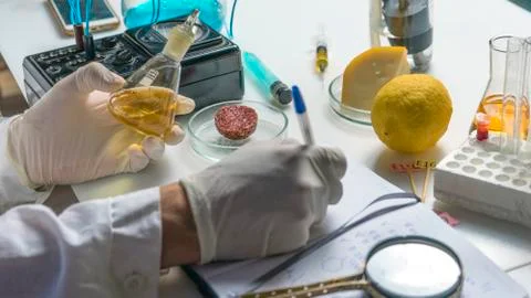 Laboratory assistant at the workplace makes notes in a notebook. Laboratory p Stock Photos