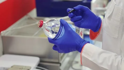 Laboratory assistant writes on a bottle of glycerol Stock Footage 234813895