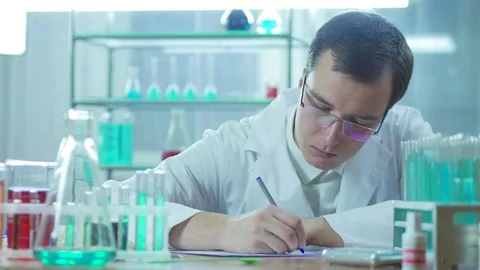 The laboratory assistant writes on paper in the laboratory Stock Footage 83211070